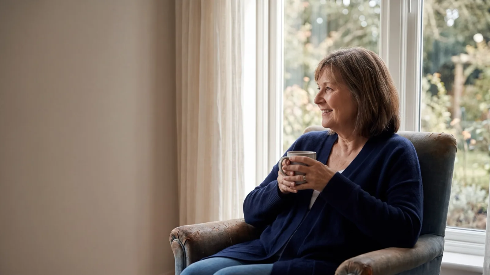 A woman relaxing with tea by a sunlit window