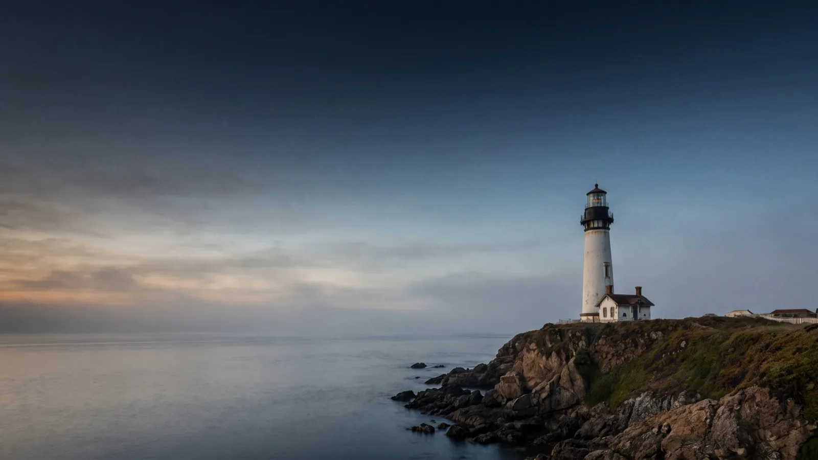 A lighthouse standing firm on a rocky coast