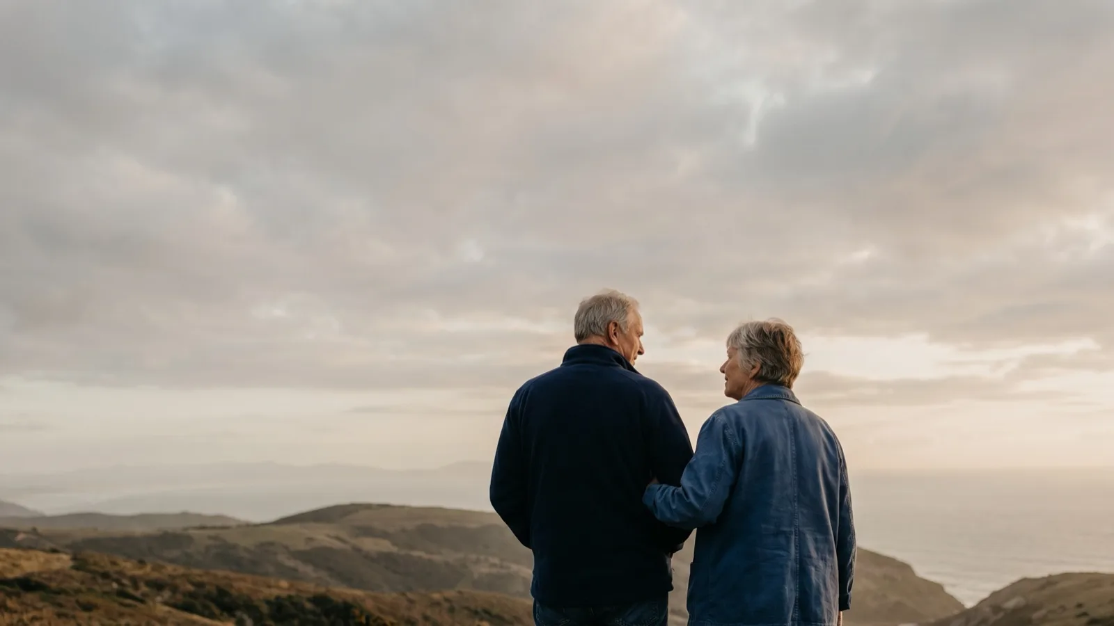 A senior couple looking out over a hilltop horizon